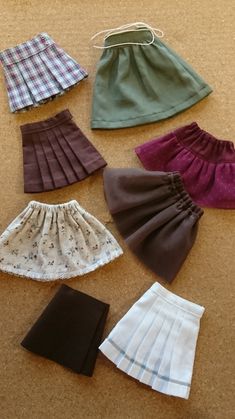 several different types of skirts laid out on the floor