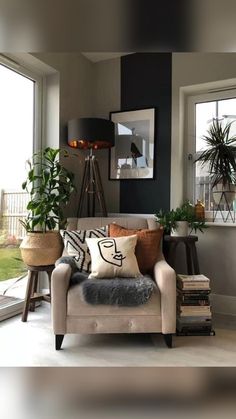 a living room filled with furniture and lots of plants