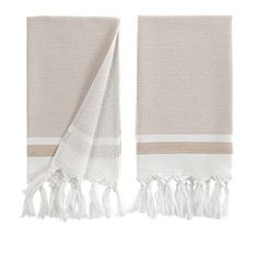 two white towels with tassels on each side and one has a beige stripe