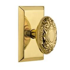 an ornate brass door knob with a decorative design on the front and back side of it