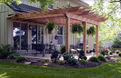 an old photo of a patio with potted plants on the front and back porch