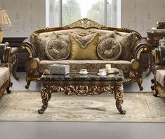 a fancy living room set with gold accents and ornate details on the couches, loveseat, coffee table and end tables