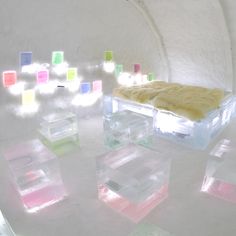 there are many different colored boxes on the table and in the room, one is filled with ice cubes