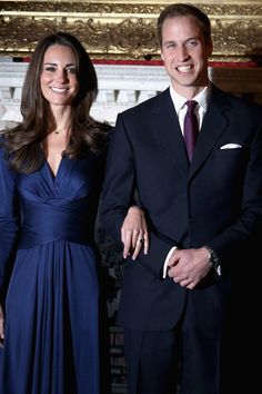 a man and woman in formal wear standing next to each other