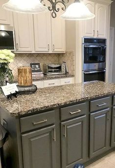 a kitchen with granite counter tops and white cabinets