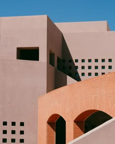 the building is made of red bricks and has two arched doorways on each side