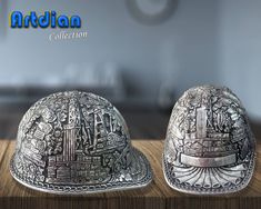 two silver hats sitting on top of a wooden table