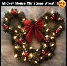 a heart shaped wreath with lights and a red bow