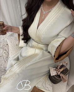 Moroccan white elegant Caftan with a brown lining, this dress is made to order and can be customized. Traditional V-neck Abaya For Wedding, Elegant V-neck Wedding Abaya, Elegant Formal Gown For Eid, Elegant Long Beige Abaya, White Dress For Eid Ceremony, White Dresses For Eid Ceremony, Elegant Cream Long Sleeve Abaya, Luxury Fitted Dresses For Eid, Elegant White V-neck Kaftan