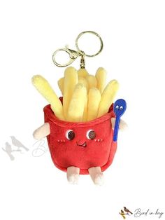 a stuffed toy in a red bag with french fries inside it and a blue pair of scissors hanging from the handle