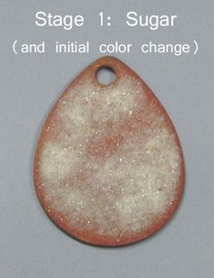 an orange and white pendant with the words, stage 1 sugar and initial color change