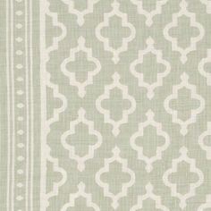 a light green and white fabric with an intricate design on the bottom half of it