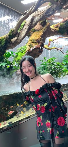 a woman standing in front of an aquarium