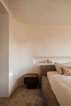 a bed sitting next to a window in a bedroom on top of a carpeted floor