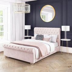 a bedroom with blue walls and white bedding in the center is an elegant chandelier