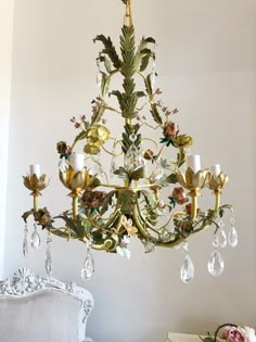 a chandelier hanging from the ceiling in a room with white walls and furniture