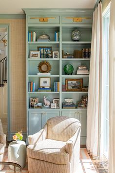 a living room filled with furniture and bookshelves