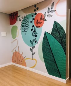 an empty room with painted leaves on the wall