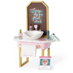 a doll's bathroom with a sink, mirror and bathtub in the shape of a sign