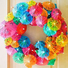 a wreath made out of umbrellas hanging on a door