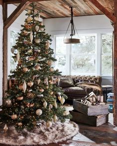 a living room with a christmas tree in the corner