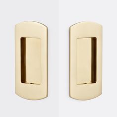 two gold door knobs on a white wall, one has a square handle and the other has a rounded design