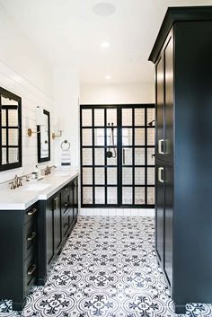 a black and white bathroom with double sinks