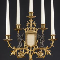 an ornate gold candelabra with white candles