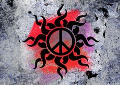 a peace sign painted on the side of a cement wall with red and black paint