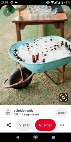 a wheelbarrow filled with beer bottles and ice