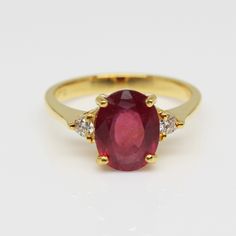 an oval shaped ruby and diamond ring