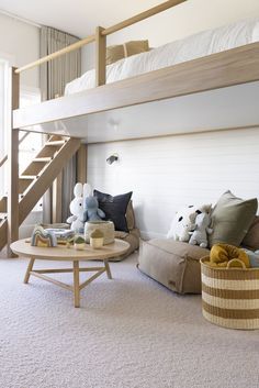 there is a bunk bed in the living room with stuffed animals on the couches