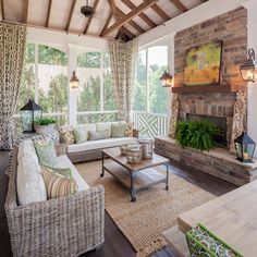 a living room filled with furniture and a fire place in front of a window on top of a wooden floor