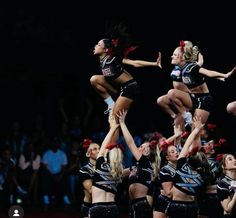 a group of cheerleaders performing in front of a crowd