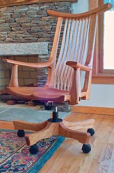 an office chair sitting in front of a stone fireplace with a rug on the floor