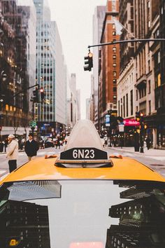 taxi cabs and people on the street in new york city