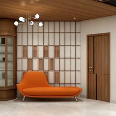 an orange couch sitting in front of a wooden cabinet and glass display case on the wall