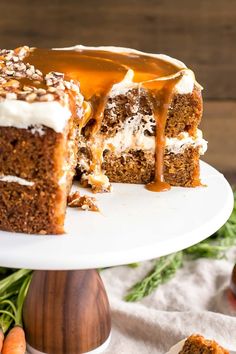 a carrot cake with white frosting and caramel drizzle