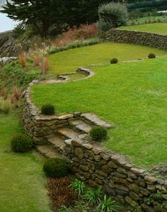 an outdoor area with grass, rocks and trees