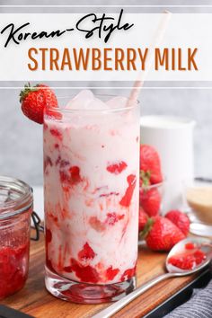 a strawberry milkshake in a glass with strawberries on the side and text overlay that reads korean style strawberry milkshake