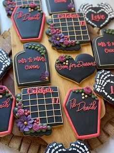 decorated cookies are arranged on a wooden platter