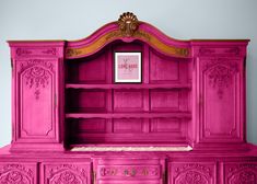 a pink dresser with gold trim and ornate carvings on the top, painted bright pink