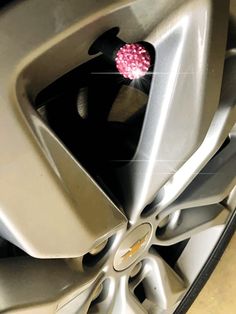 a car wheel with a pink flower in the center