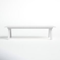 a white table sitting on top of a white floor