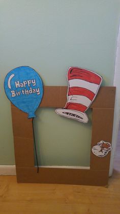 a cat in the hat birthday card and balloon on top of a cardboard box frame