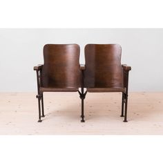 a pair of leather chairs sitting on top of a wooden floor