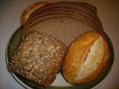 an assortment of breads and pastries on a plate