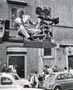 a man sitting on top of a movie camera