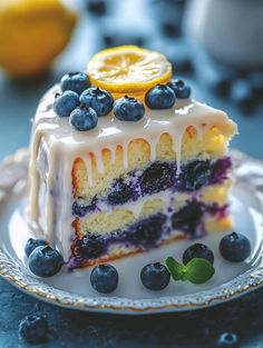 a slice of cake with blueberries and lemons on top is sitting on a plate