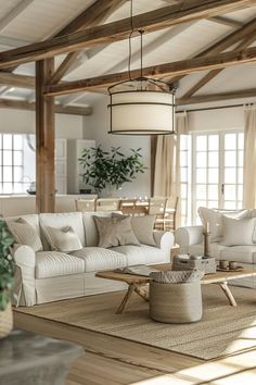 a living room filled with white furniture and lots of windows